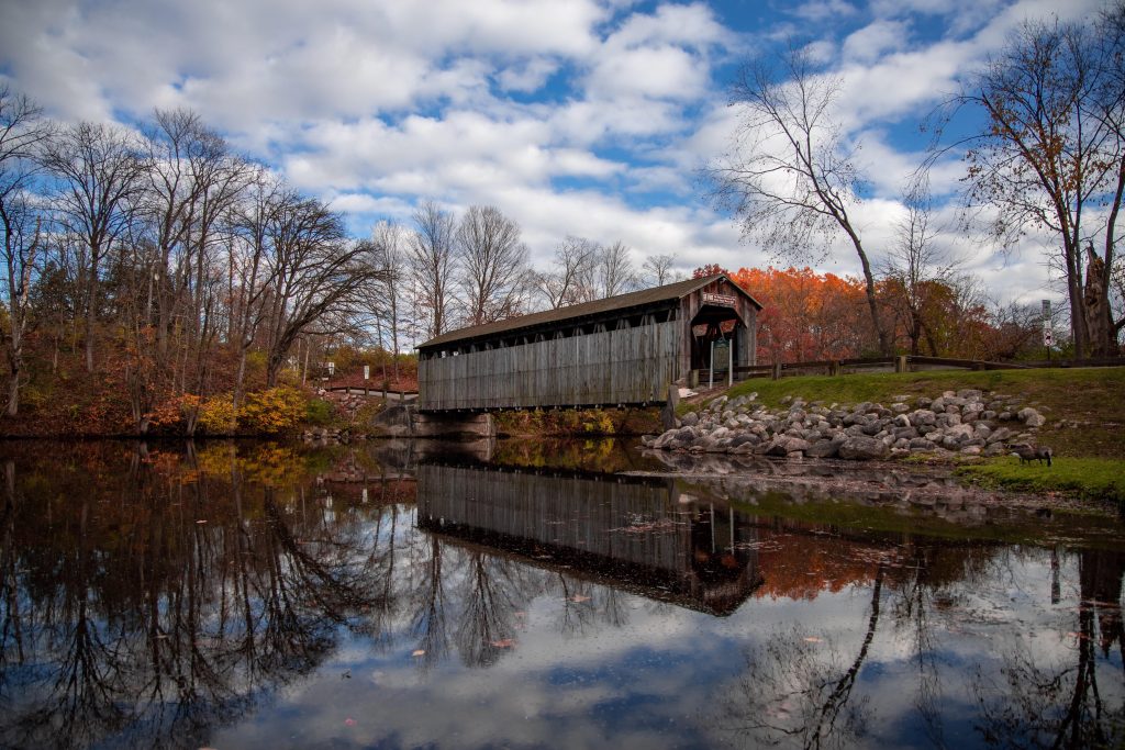 A quiet autumn moment at Fallasburg Covered Bridge as fall foliage surrounds the Flat River. Credit: u/worldwarAZ via r/Michigan